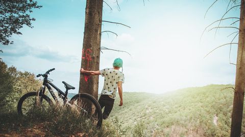 Radfahrer macht eine Pause und genießt die Aussicht auf die sanften Hügel